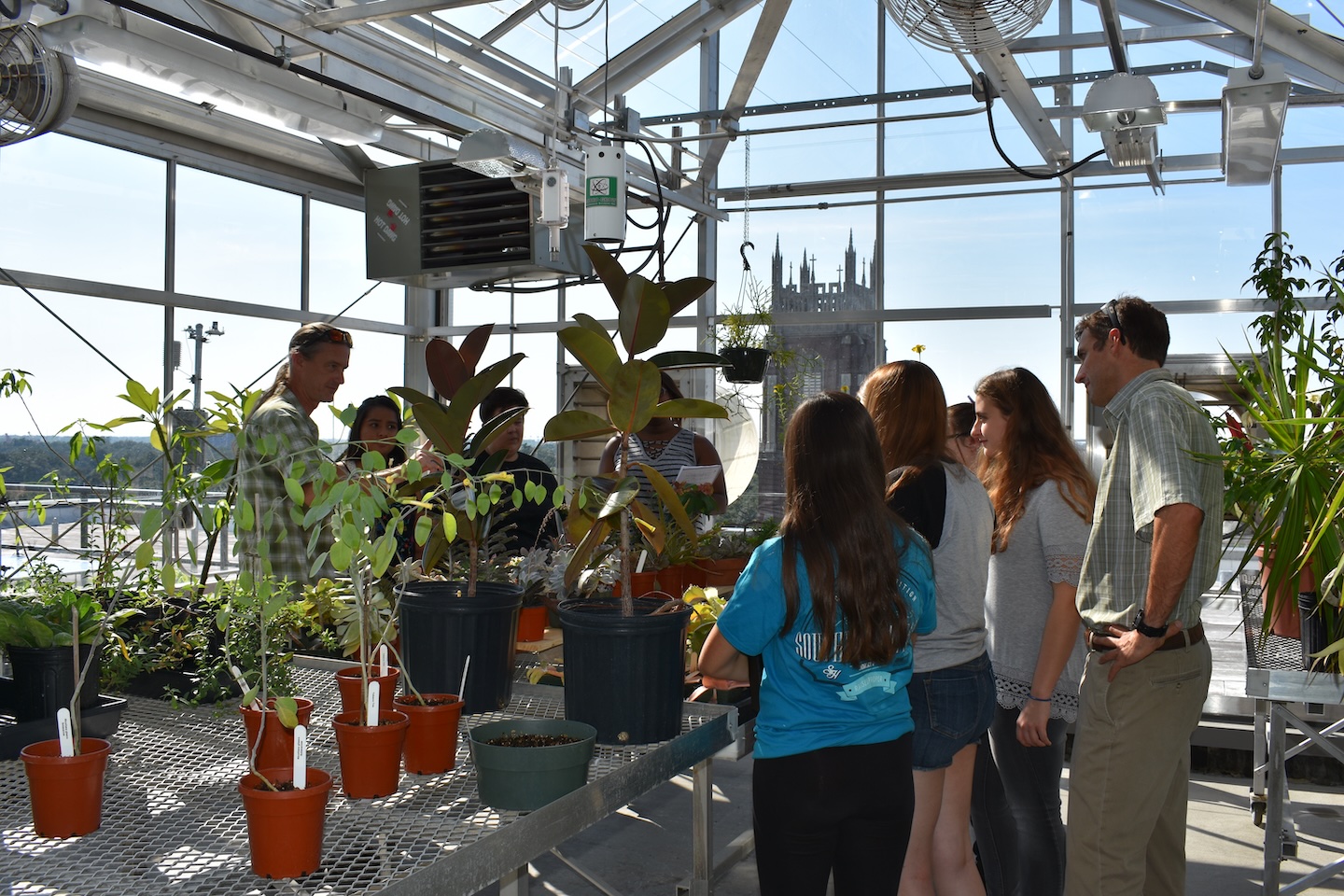 Students and faculty in the Loyola Azby Greenhouse